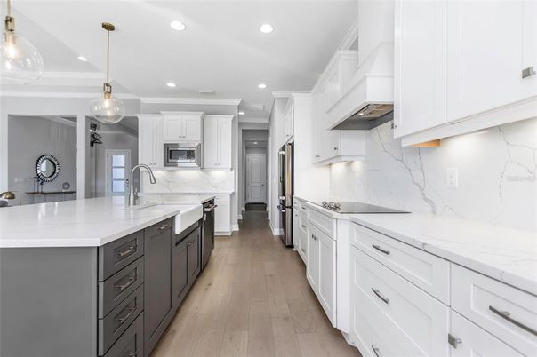 Interior, Kitchen, Marble Walls, Pendant Lights, Recessed Lighting, Stainless Steel Appliances, Wood Texture Flooring