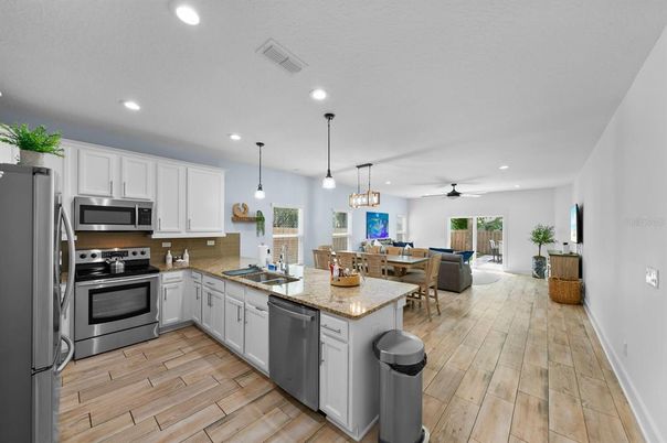 Dining room, Interior, Kitchen, Living room, Pendant Lights, Recessed Lighting, Stainless Steel Appliances, Wood Texture Flooring