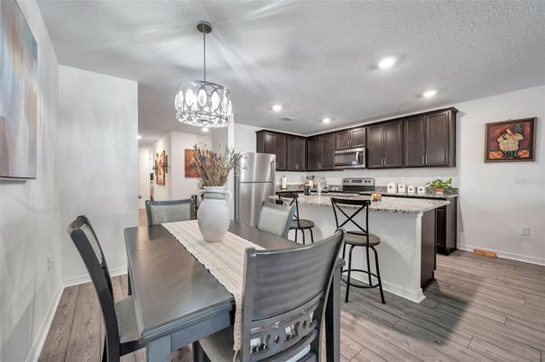Chandelier, Dining room, Interior, Kitchen, Pendant Lights, Recessed Lighting, Stainless Steel Appliances, Wood Texture Flooring