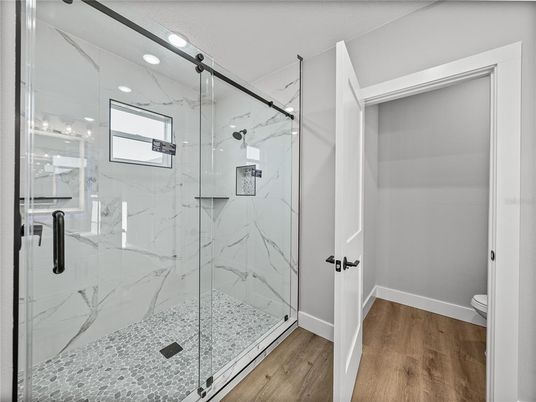 Bathroom, Glass Shower, Interior, Marble Walls, Recessed Lighting, Wood Texture Flooring