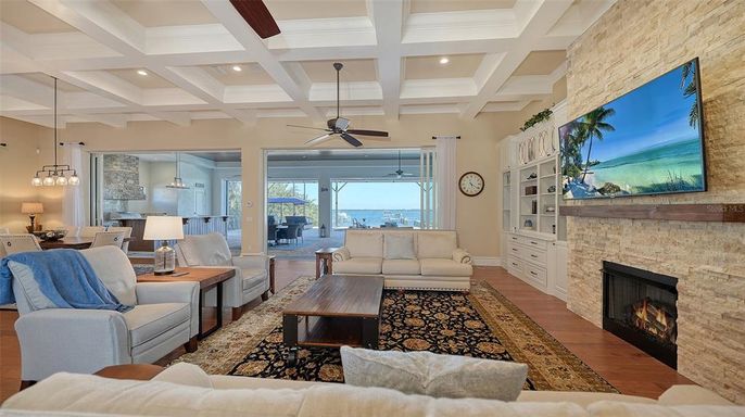 Dining room, Fireplace, Interior, Living room, Pendant Lights, Recessed Lighting, Stone Walls, Water, Wood Texture Flooring