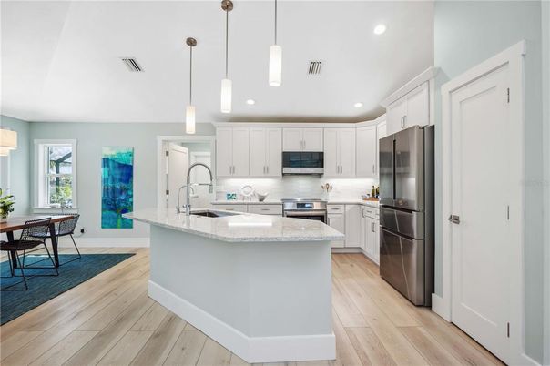 Dining room, Interior, Kitchen, Pendant Lights, Recessed Lighting, Stainless Steel Appliances, Wood Texture Flooring