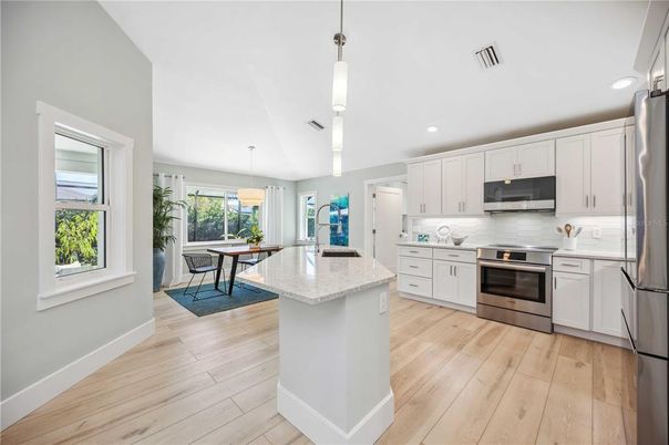 Dining room, Interior, Kitchen, Pendant Lights, Recessed Lighting, Stainless Steel Appliances, Wood Texture Flooring