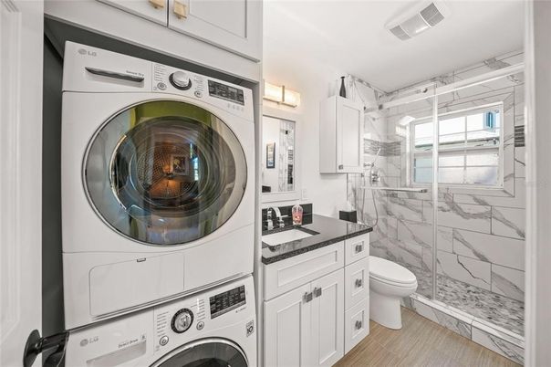 Bathroom, Glass Shower, Interior, Marble Walls, Utility Closets, Washer, Wood Texture Flooring