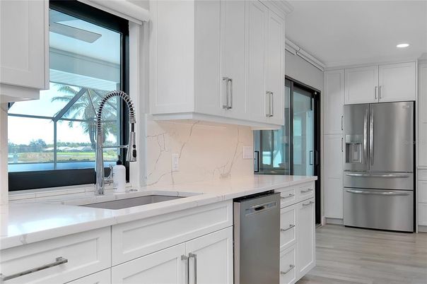 Interior, Kitchen, Marble Walls, Recessed Lighting, Stainless Steel Appliances, Wood Texture Flooring
