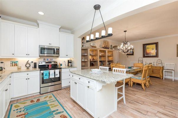 Chandelier, Dining room, Interior, Kitchen, Pendant Lights, Recessed Lighting, Stainless Steel Appliances, Wood Texture Flooring