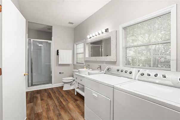 Bathroom, Glass Shower, Interior, Washer, Wood Texture Flooring