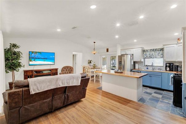 Chandelier, Dining room, Interior, Kitchen, Living room, Pendant Lights, Recessed Lighting, Stainless Steel Appliances, Wood Texture Flooring