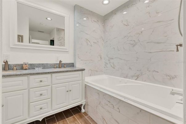 Bathroom, Dual Sink Vanities, Interior, Marble Walls, Recessed Lighting, Wood Texture Flooring