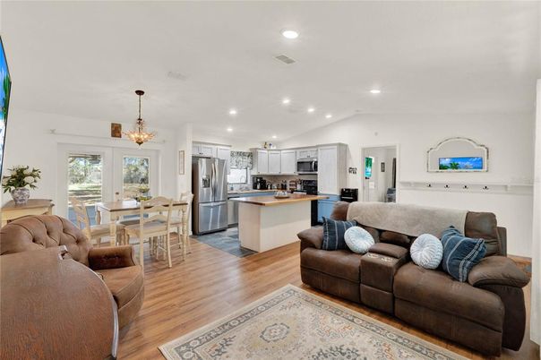 Chandelier, Dining room, Interior, Kitchen, Living room, Pendant Lights, Recessed Lighting, Stainless Steel Appliances, Wood Texture Flooring
