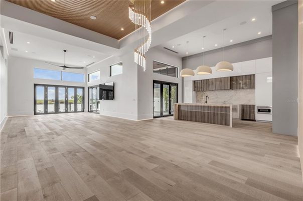 Chandelier, Interior, Kitchen, Marble Walls, Pendant Lights, Recessed Lighting, Stainless Steel Appliances, Wood Texture Flooring