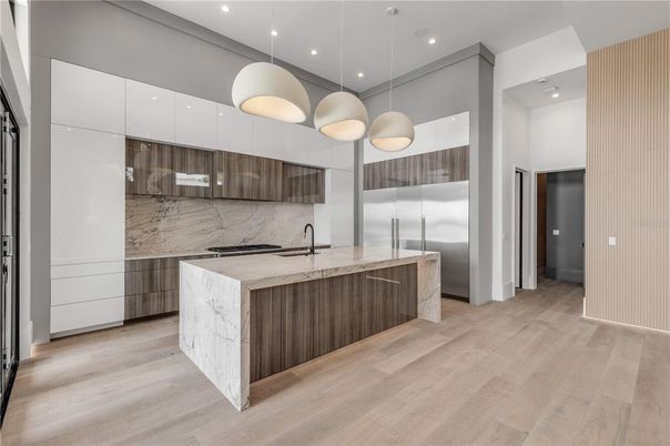 Interior, Kitchen, Marble Walls, Pendant Lights, Recessed Lighting, Stainless Steel Appliances, Wood Texture Flooring