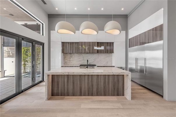 Interior, Kitchen, Marble Walls, Pendant Lights, Recessed Lighting, Stainless Steel Appliances, Wood Texture Flooring