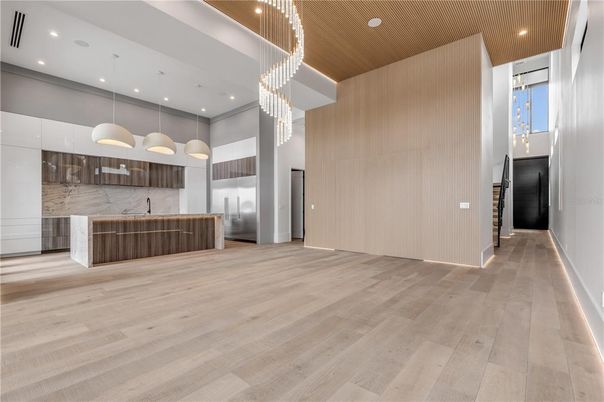 Chandelier, Interior, Kitchen, Marble Walls, Pendant Lights, Recessed Lighting, Stainless Steel Appliances, Wood Texture Flooring