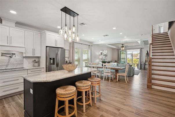 Dining room, Interior, Kitchen, Pendant Lights, Recessed Lighting, Stainless Steel Appliances, Wood Texture Flooring