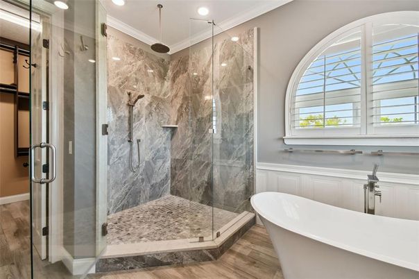 Bathroom, Free Standing Baths, Glass Shower, Interior, Marble Walls, Recessed Lighting, Wood Texture Flooring