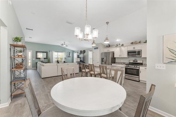 Chandelier, Dining room, Interior, Kitchen, Living room, Pendant Lights, Recessed Lighting, Stainless Steel Appliances, Wood Texture Flooring