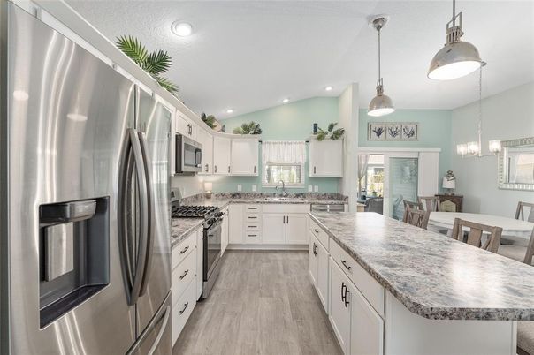 Dining room, Interior, Kitchen, Pendant Lights, Recessed Lighting, Stainless Steel Appliances, Wood Texture Flooring