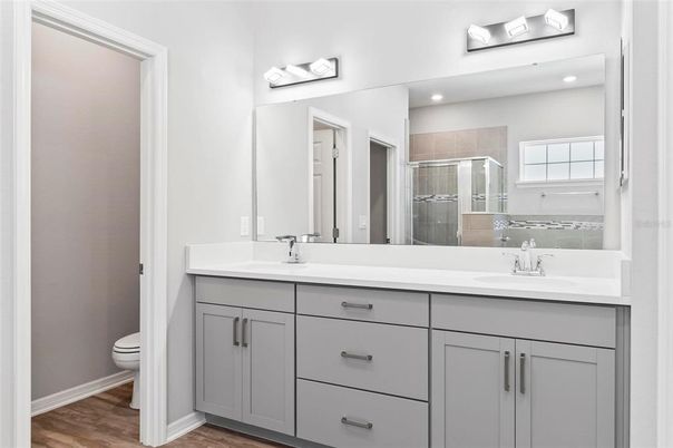 Bathroom, Dual Sink Vanities, Glass Shower, Interior, Recessed Lighting, Wood Texture Flooring