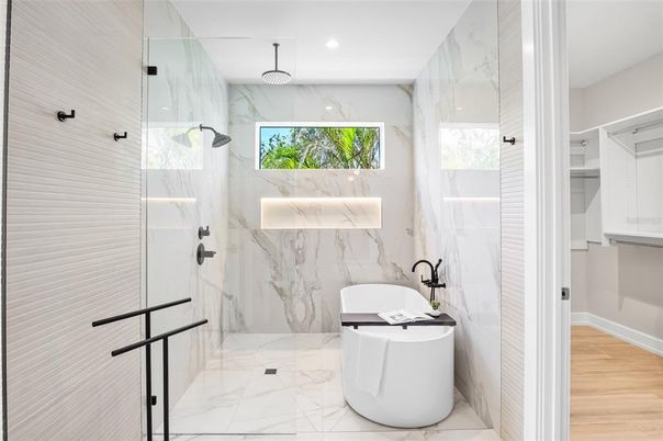 Bathroom, Free Standing Baths, Glass Shower, Interior, Marble, Marble Walls, Recessed Lighting, Wood Texture Flooring