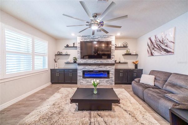 Fireplace, Interior, Living room, Recessed Lighting, Stone Walls, Wood Texture Flooring