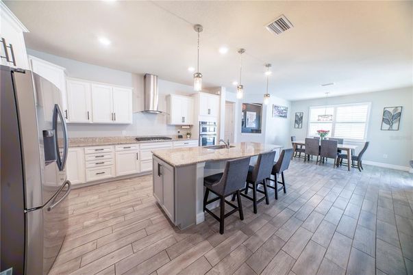 Dining room, Interior, Kitchen, Pendant Lights, Recessed Lighting, Stainless Steel Appliances, Wood Texture Flooring