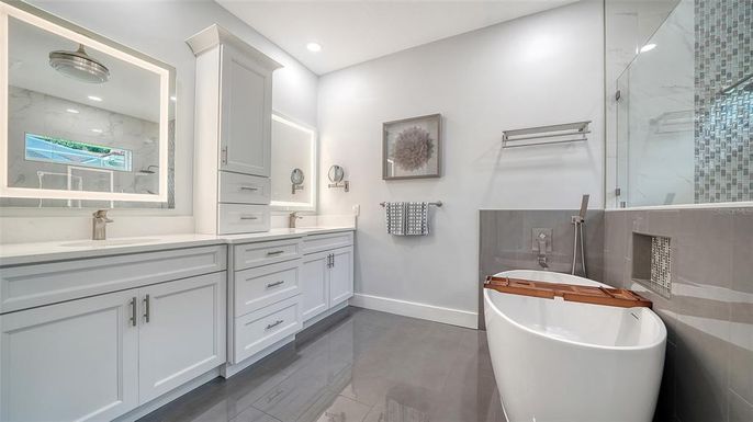 Bathroom, Dual Sink Vanities, Free Standing Baths, Glass Shower, Interior, Marble Walls, Recessed Lighting, Wood Texture Flooring
