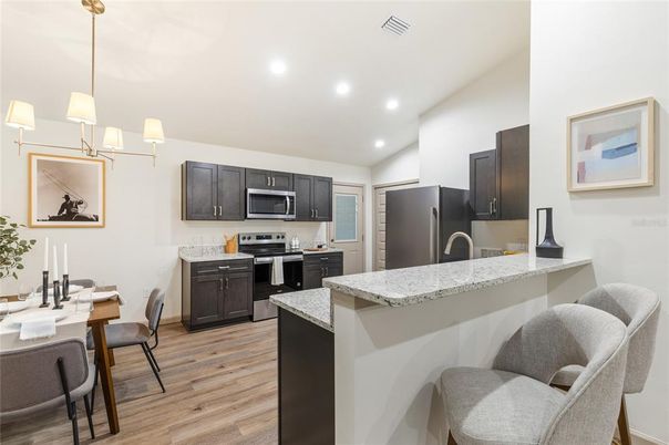 Chandelier, Dining room, Interior, Kitchen, Pendant Lights, Recessed Lighting, Stainless Steel Appliances, Wood Texture Flooring