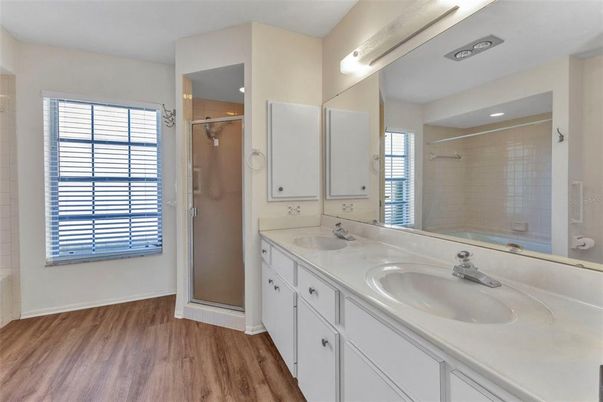 Bathroom, Dual Sink Vanities, Glass Shower, Interior, Recessed Lighting, Wood Texture Flooring