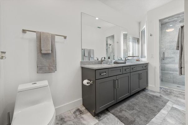 Bathroom, Dual Sink Vanities, Glass Shower, Interior, Marble, Marble Walls, Recessed Lighting