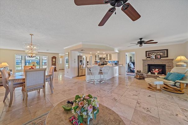 Chandelier, Dining room, Fireplace, Interior, Kitchen, Living room, Recessed Lighting, Stainless Steel Appliances