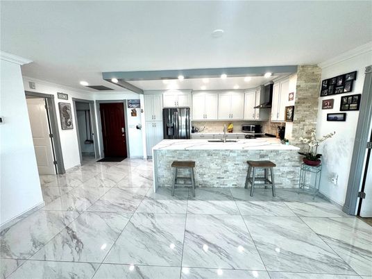 Interior, Kitchen, Marble, Recessed Lighting, Stainless Steel Appliances, Stone Walls