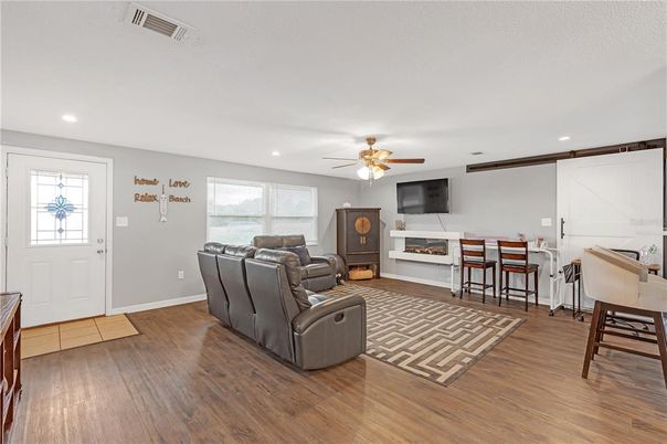 Dining room, Fireplace, Interior, Living room, Recessed Lighting, Wood Texture Flooring