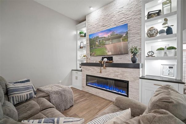 Fireplace, Interior, Living room, Recessed Lighting, Stone Walls, Wood Texture Flooring