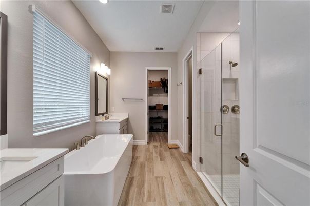 Bathroom, Dual Sink Vanities, Free Standing Baths, Glass Shower, Interior, Recessed Lighting, Wood Texture Flooring