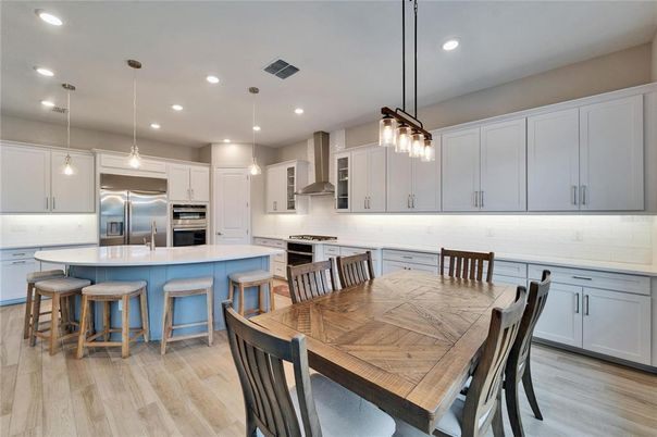 Dining room, Interior, Kitchen, Pendant Lights, Recessed Lighting, Stainless Steel Appliances, Wood Texture Flooring