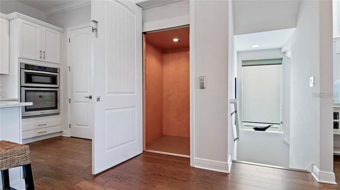 Interior, Kitchen, Recessed Lighting, Stainless Steel Appliances, Wood Texture Flooring, Wooden Walls