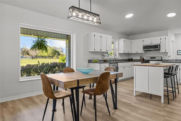 Dining room, Interior, Kitchen, Pendant Lights, Recessed Lighting, Stainless Steel Appliances, Wood Texture Flooring