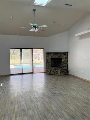 Empty room, Fireplace, Interior, Recessed Lighting, Stone Walls, Wood Texture Flooring