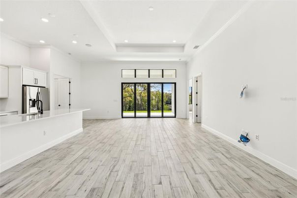Empty room, Interior, Kitchen, Recessed Lighting, Stainless Steel Appliances, Wood Texture Flooring