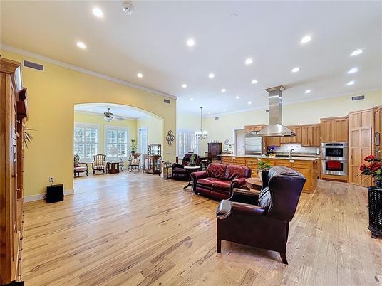 Chandelier, Dining room, Interior, Kitchen, Living room, Pendant Lights, Recessed Lighting, Stainless Steel Appliances, Wood Texture Flooring