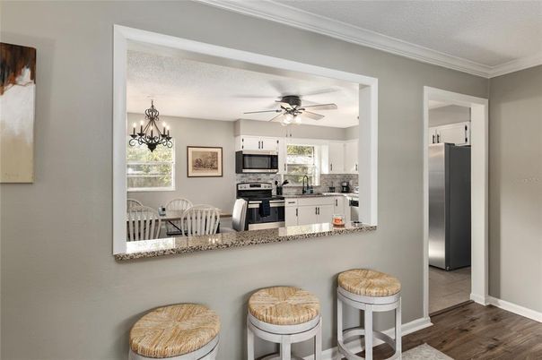 Chandelier, Dining room, Interior, Kitchen, Stainless Steel Appliances, Wood Texture Flooring