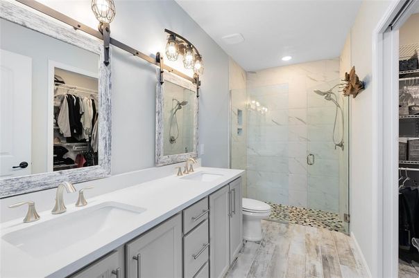 Bathroom, Dual Sink Vanities, Glass Shower, Interior, Marble Walls, Recessed Lighting, Walk-in Closets, Wood Texture Flooring