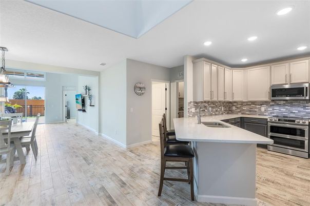 Dining room, Interior, Kitchen, Pendant Lights, Recessed Lighting, Stainless Steel Appliances, Wood Texture Flooring