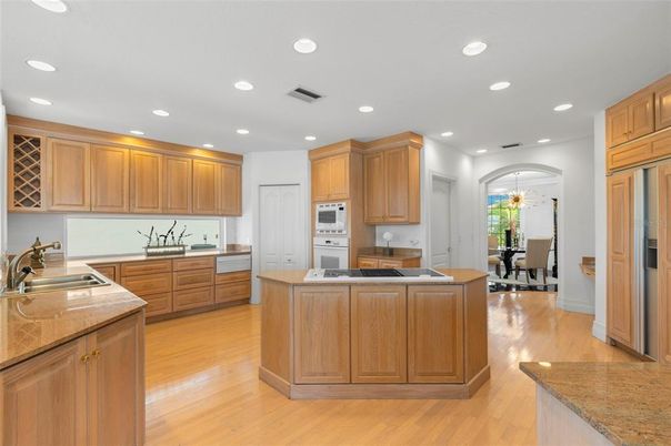 Chandelier, Dining room, Interior, Kitchen, Pendant Lights, Recessed Lighting, Stainless Steel Appliances, Wood Texture Flooring