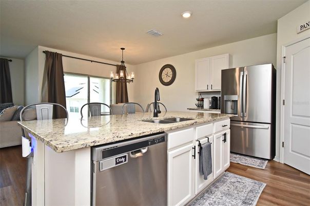 Chandelier, Dining room, Interior, Kitchen, Pendant Lights, Recessed Lighting, Stainless Steel Appliances, Wood Texture Flooring
