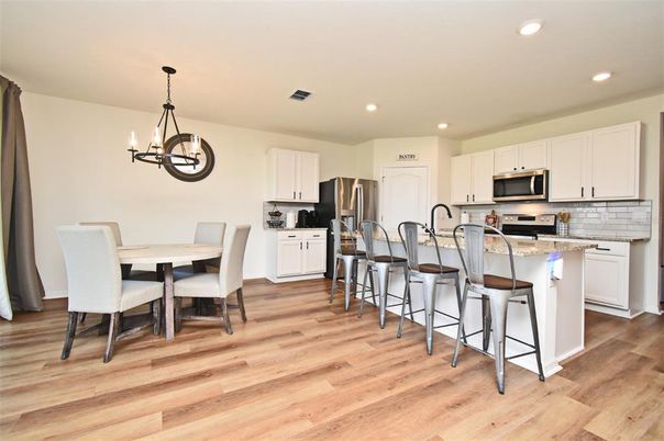 Chandelier, Dining room, Interior, Kitchen, Pendant Lights, Recessed Lighting, Stainless Steel Appliances, Wood Texture Flooring