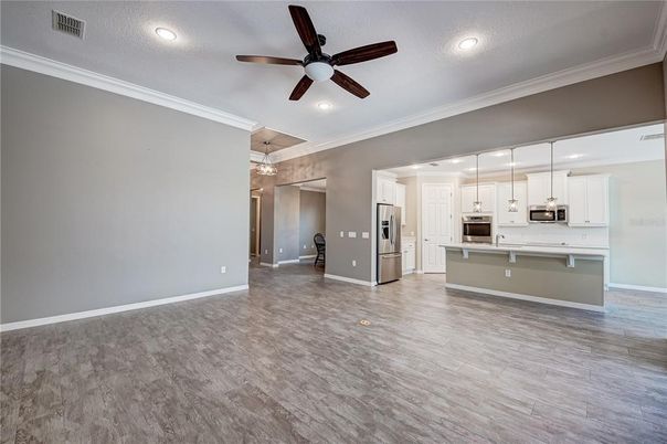 Empty room, Interior, Kitchen, Pendant Lights, Recessed Lighting, Stainless Steel Appliances, Wood Texture Flooring