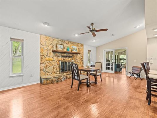 Dining room, Fireplace, Interior, Recessed Lighting, Stone Walls, Wood Texture Flooring