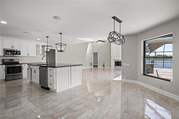 Fireplace, Interior, Kitchen, Pendant Lights, Recessed Lighting, Stainless Steel Appliances